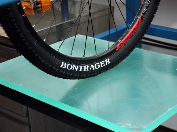 Tires are controllably compressed on the translucent surface and then the contact patch is photographed from below.