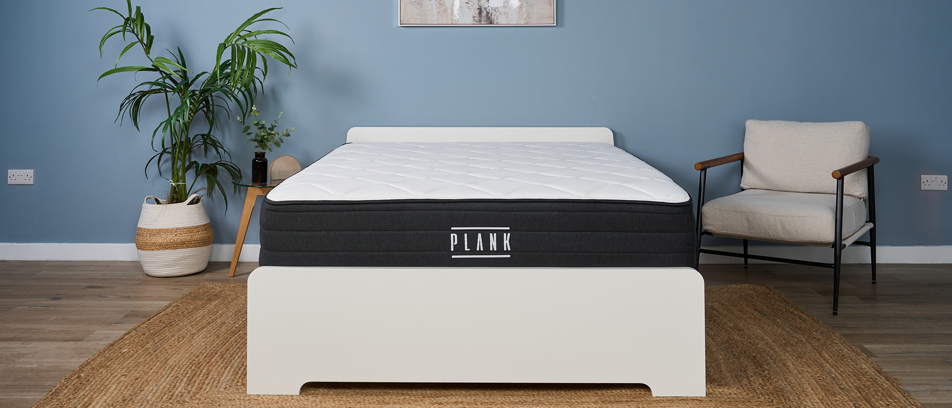 The Plank Firm Luxe mattress in our Tom's Guide sleep studio, dressed to look like a bedroom