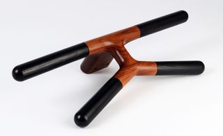 View of the 'Jeeves' valet - a black and brown wooden hook style piece pictured against a light grey background