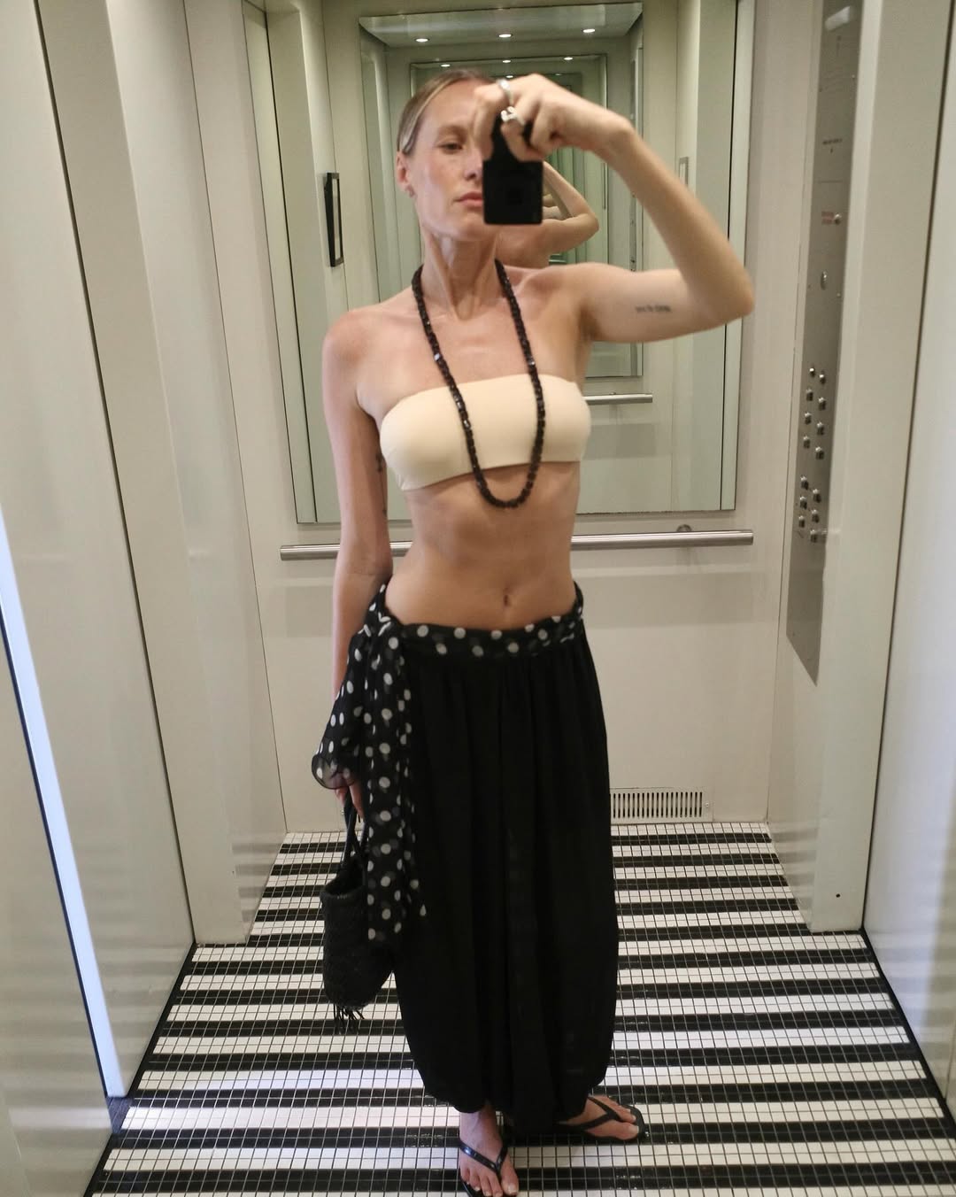 Elly Mcgaw wearing an onyx necklace