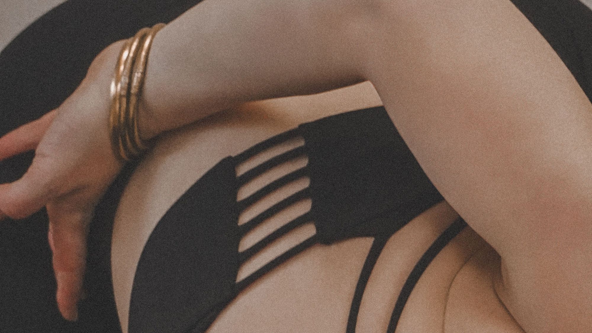 woman exercising wearing gold bracelets