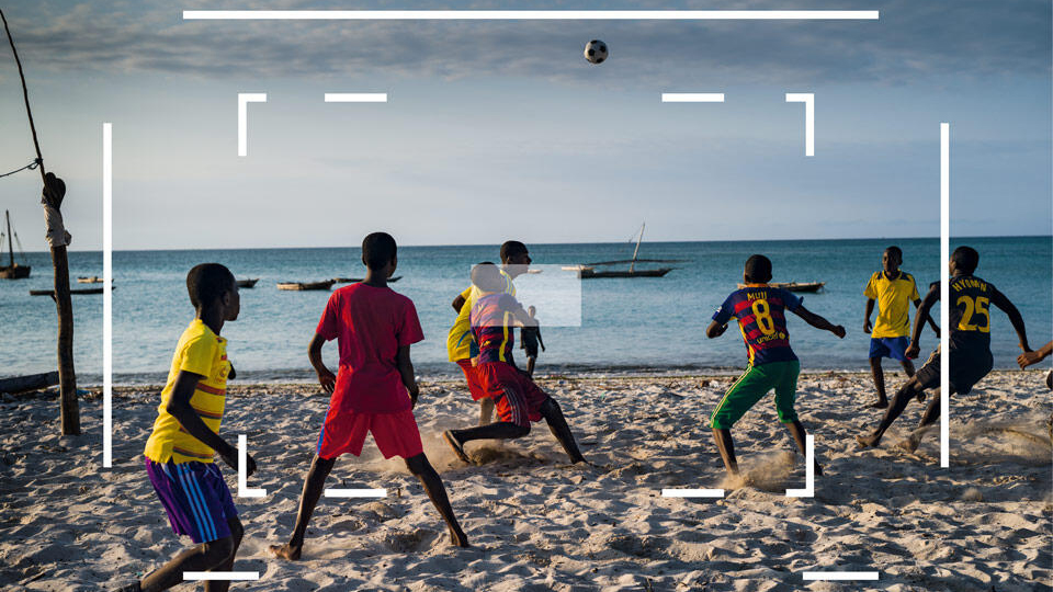 A beach football match seen through a Leica M viewfinder