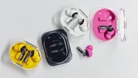 Nothing Ear (3a) wireless earbuds in various colours on a grey background