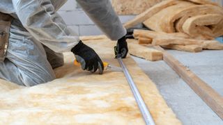 Professional workman installing thermal insulation