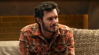 Adam Brody as Noah leaning and looking to the right in Nobody Wants This. 