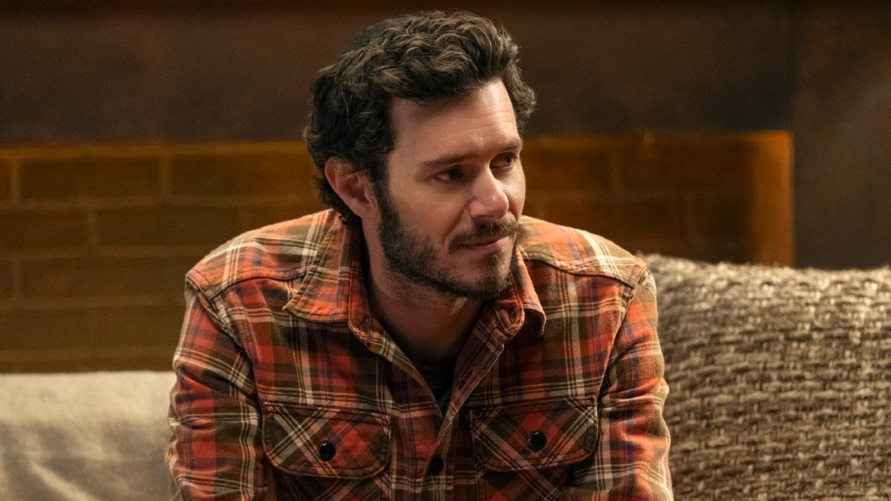 Adam Brody as Noah leaning and looking to the right in Nobody Wants This. 