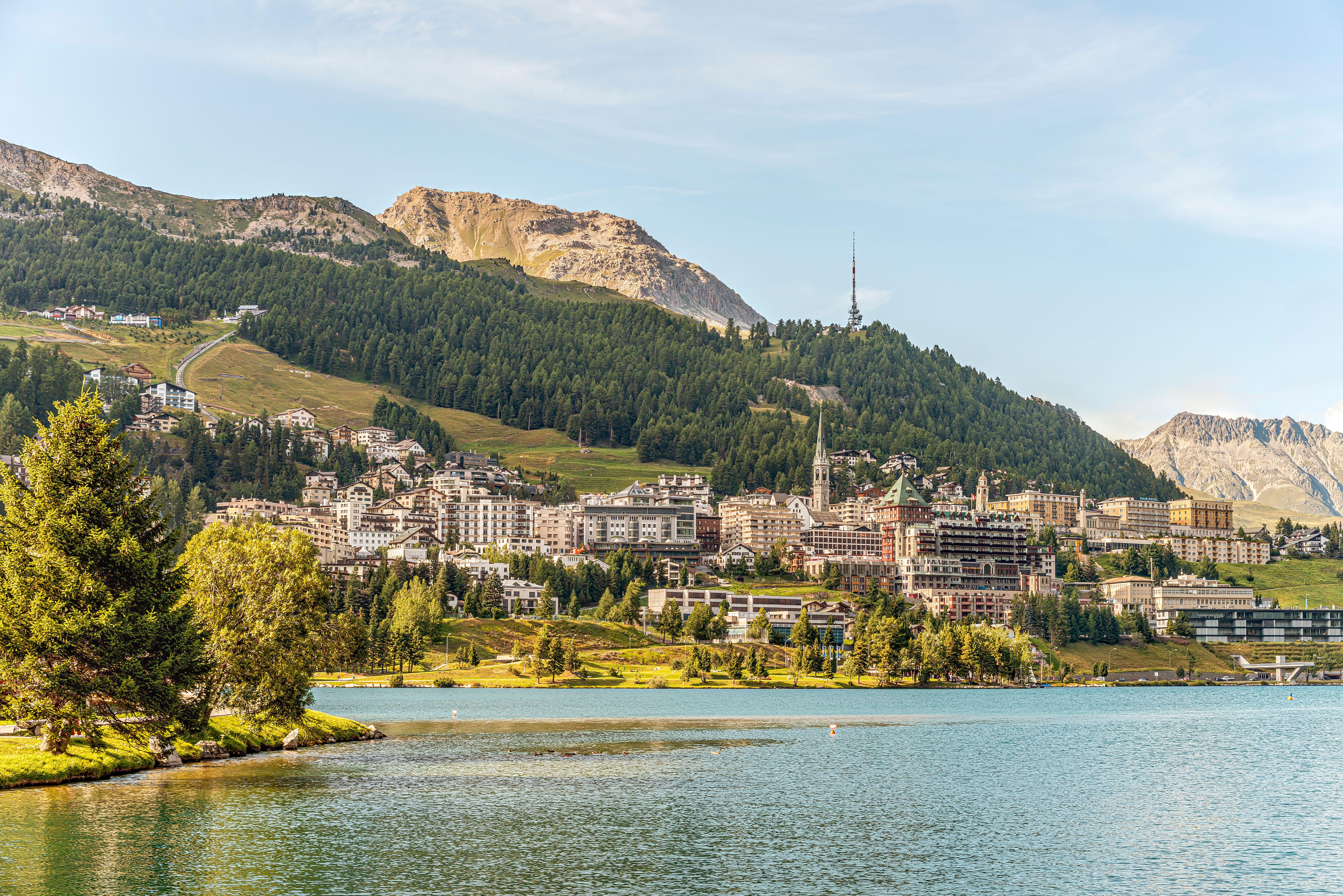 View of a mountain resort across a lake, in summer