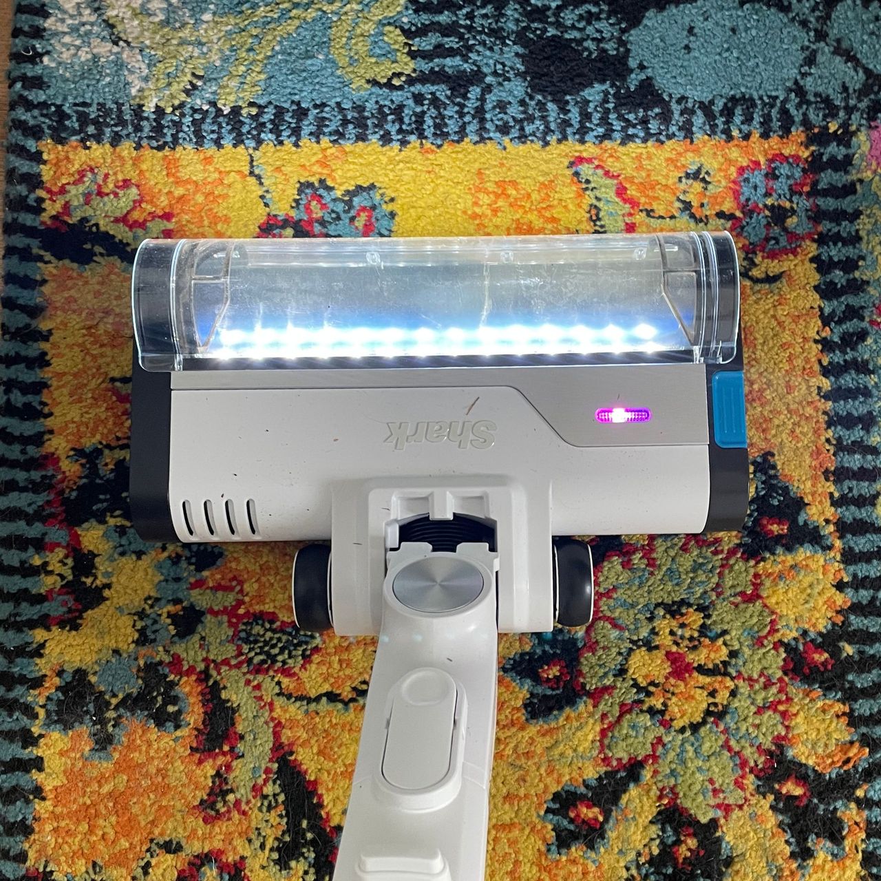 Shark PowerPro Pet Cordless Stick Vacuum floorhead on a colourful rug