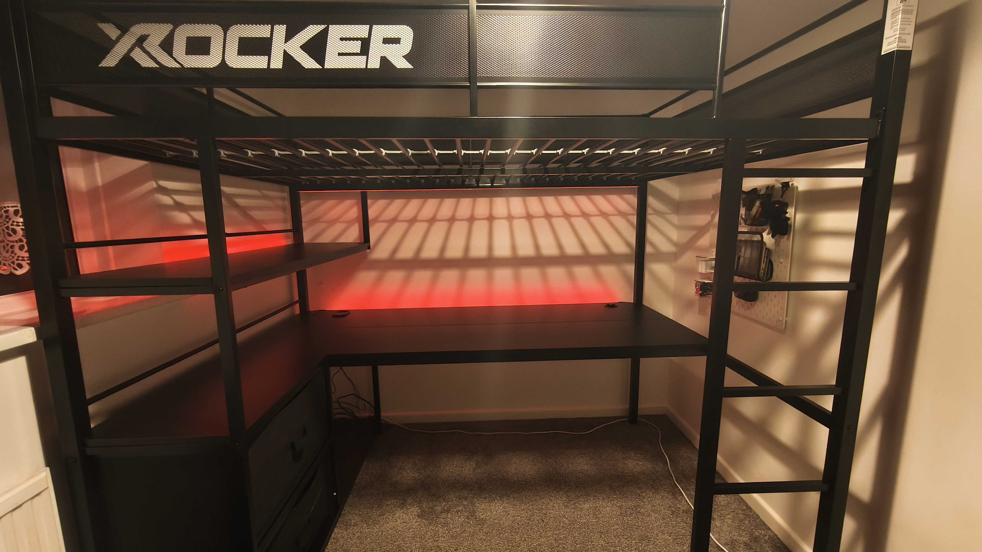 An assembled XRocker Battlebunk XL bed and desk combo inside a small bedroom