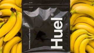 Huel Black Edition vs Bulk 1 Complete Food Shake: Huel Black Edition bag placed on top of a pile of bananas