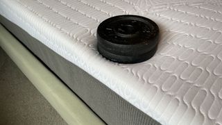 REM-Fit Hybrid 1000 mattress with weight resting on it