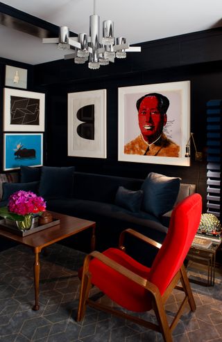 A navy blue living room with a red chair
