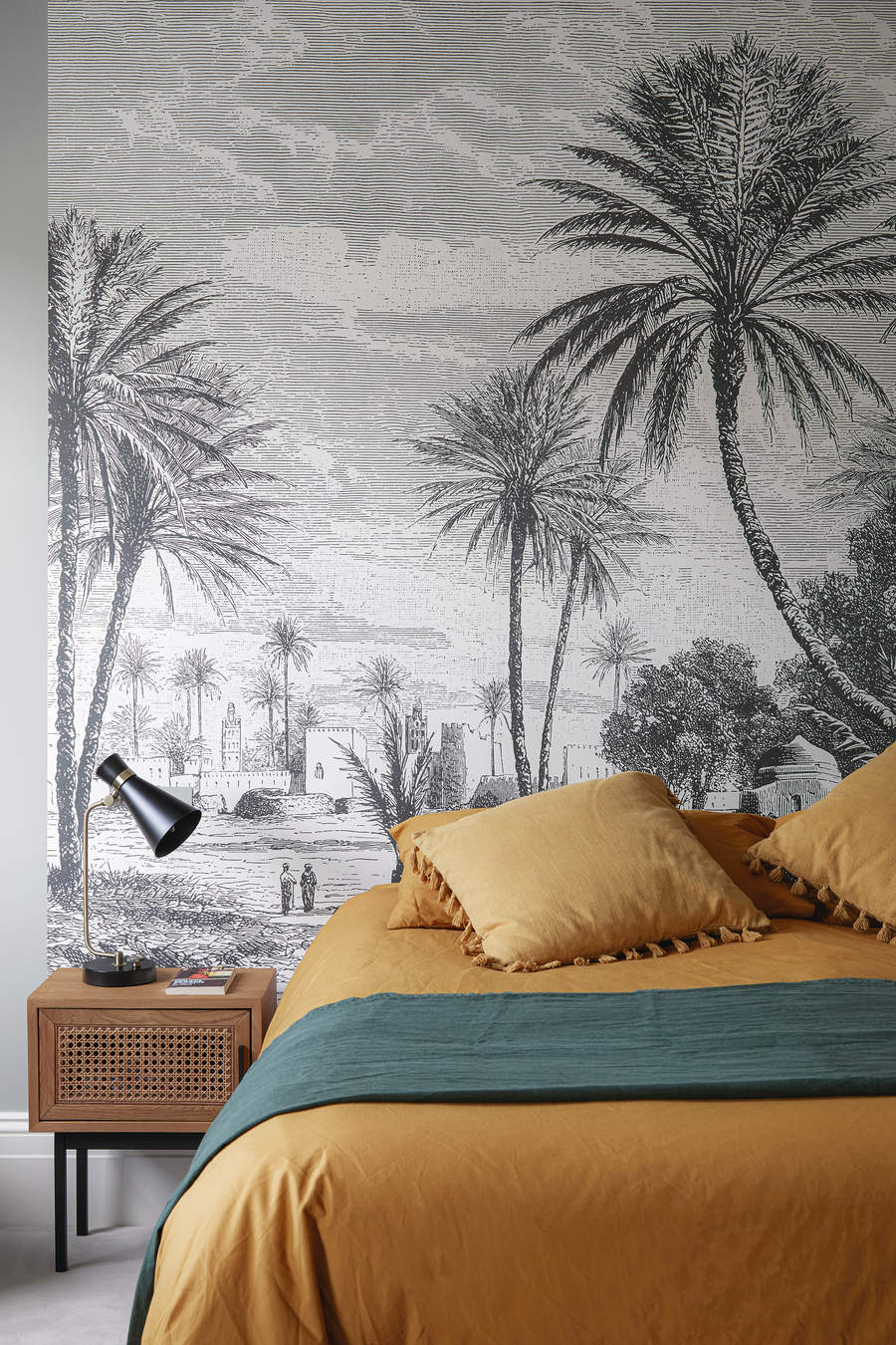 A living room with a nature inspired wallpaper in black and white