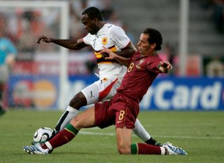 Portugal's Petit competes for the ball with Angola's Andre Mateus at the 2006 World Cup.