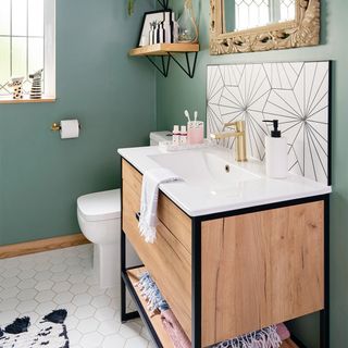 green bathroom with wooden vanity unit