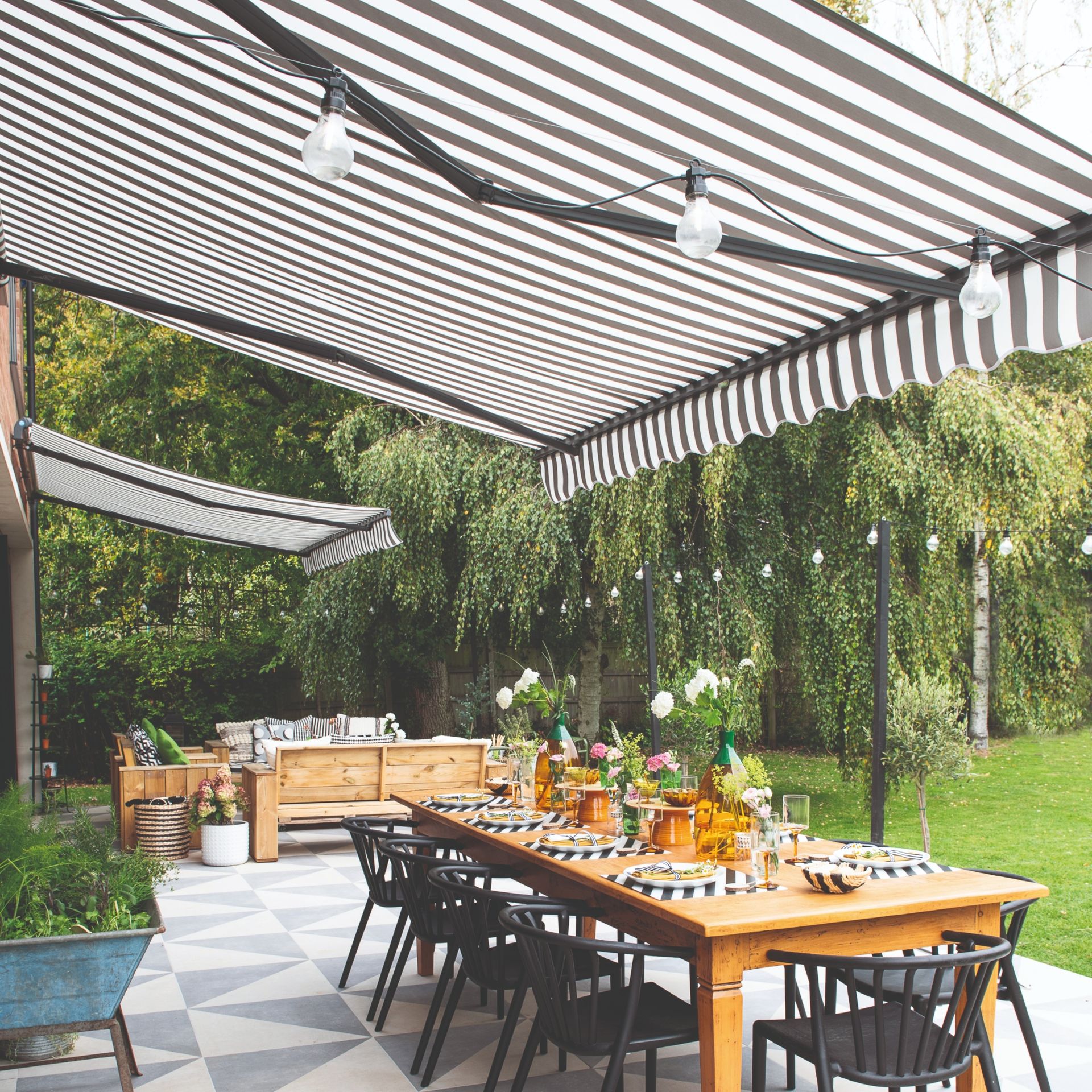 Outdoor striped awning over dining table and chairs