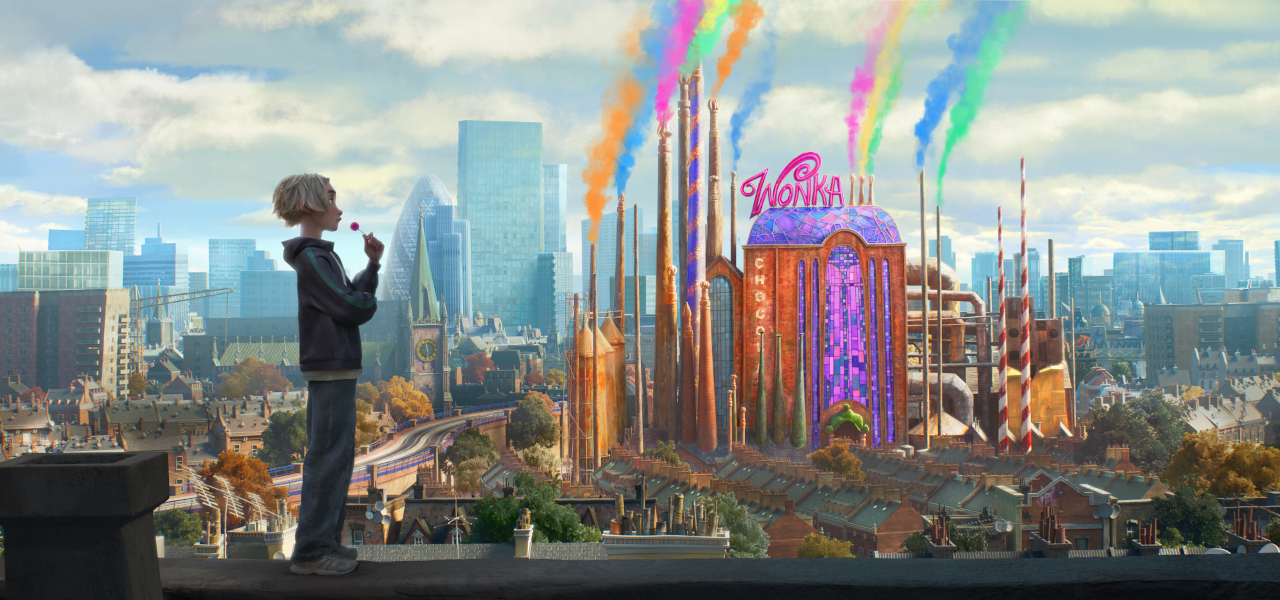 An animated blonde-haired boy stands on a rooftop looking toward a vibrant, whimsical Wonka chocolate factory that emits colorful smoke into a city skyline.
