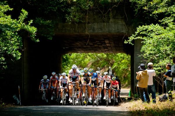 Riders pass an old tunnel in Japan cycle sports center