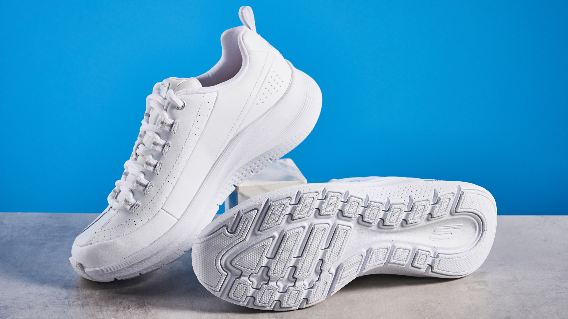 Skechers Arch Fit 2.0 Star Bound photographed in front of a blue background.
