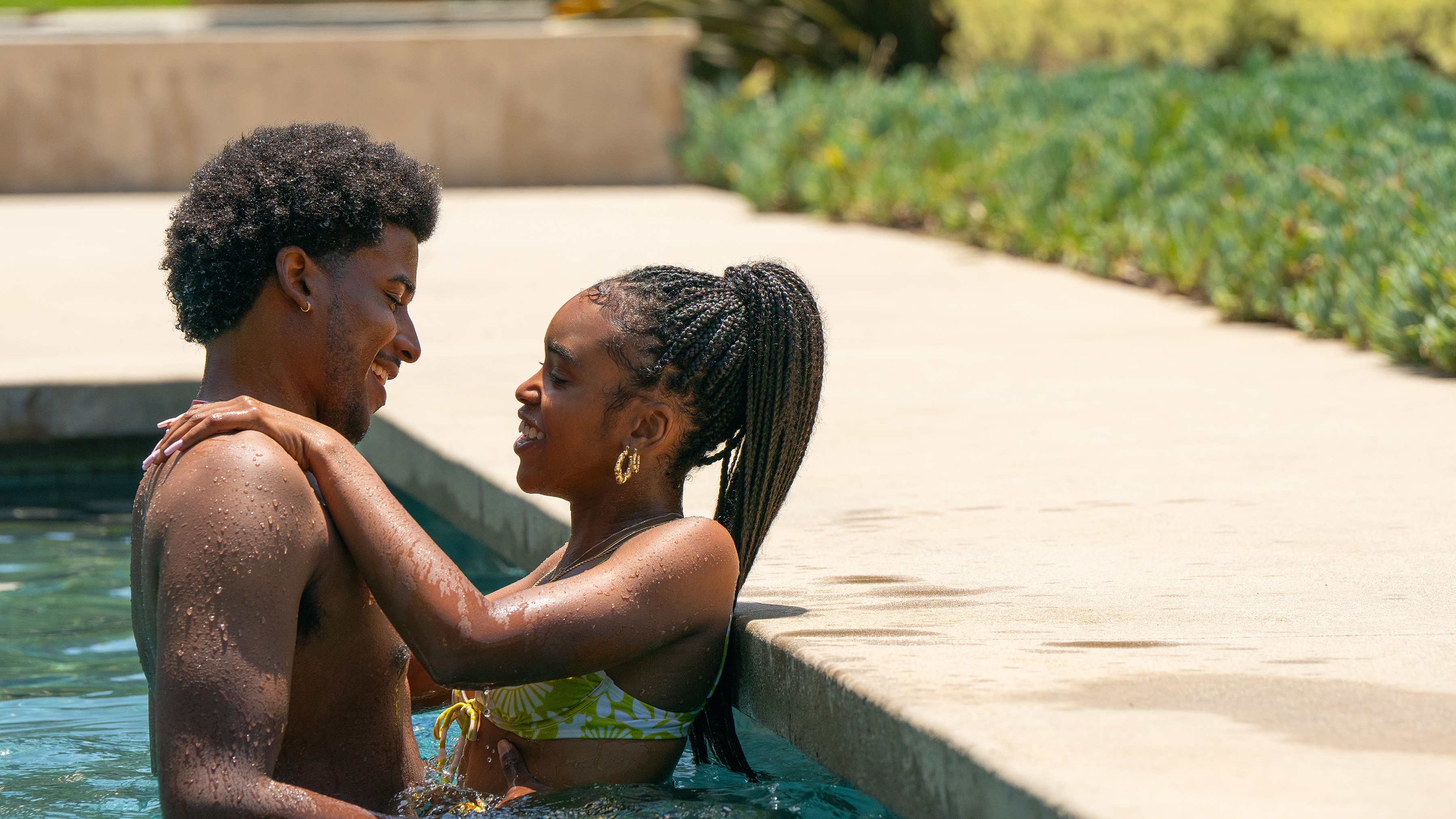 Michael Cooper Jr. and Lovie Simone as Justin and Keisha in a pool in Forever 