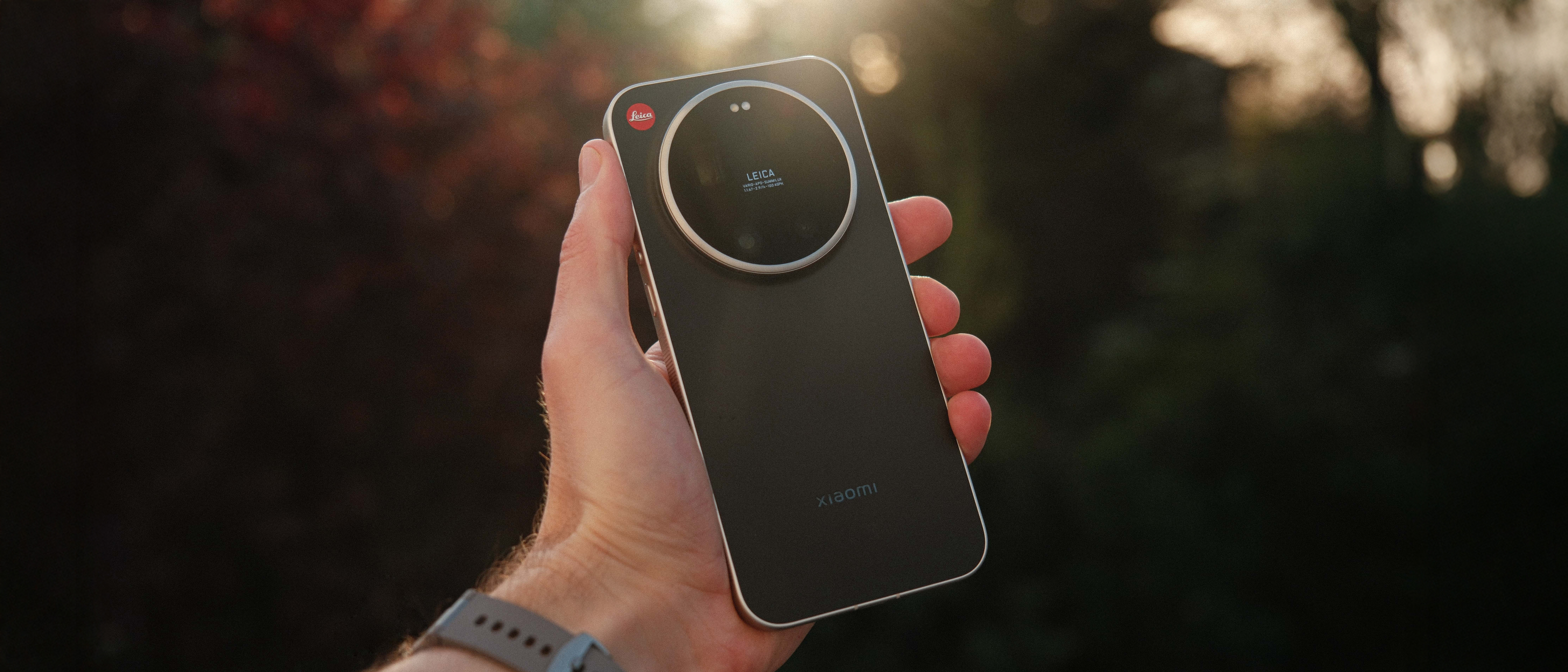 Hand holding the Leica Leitz Phone in warm outdoor light