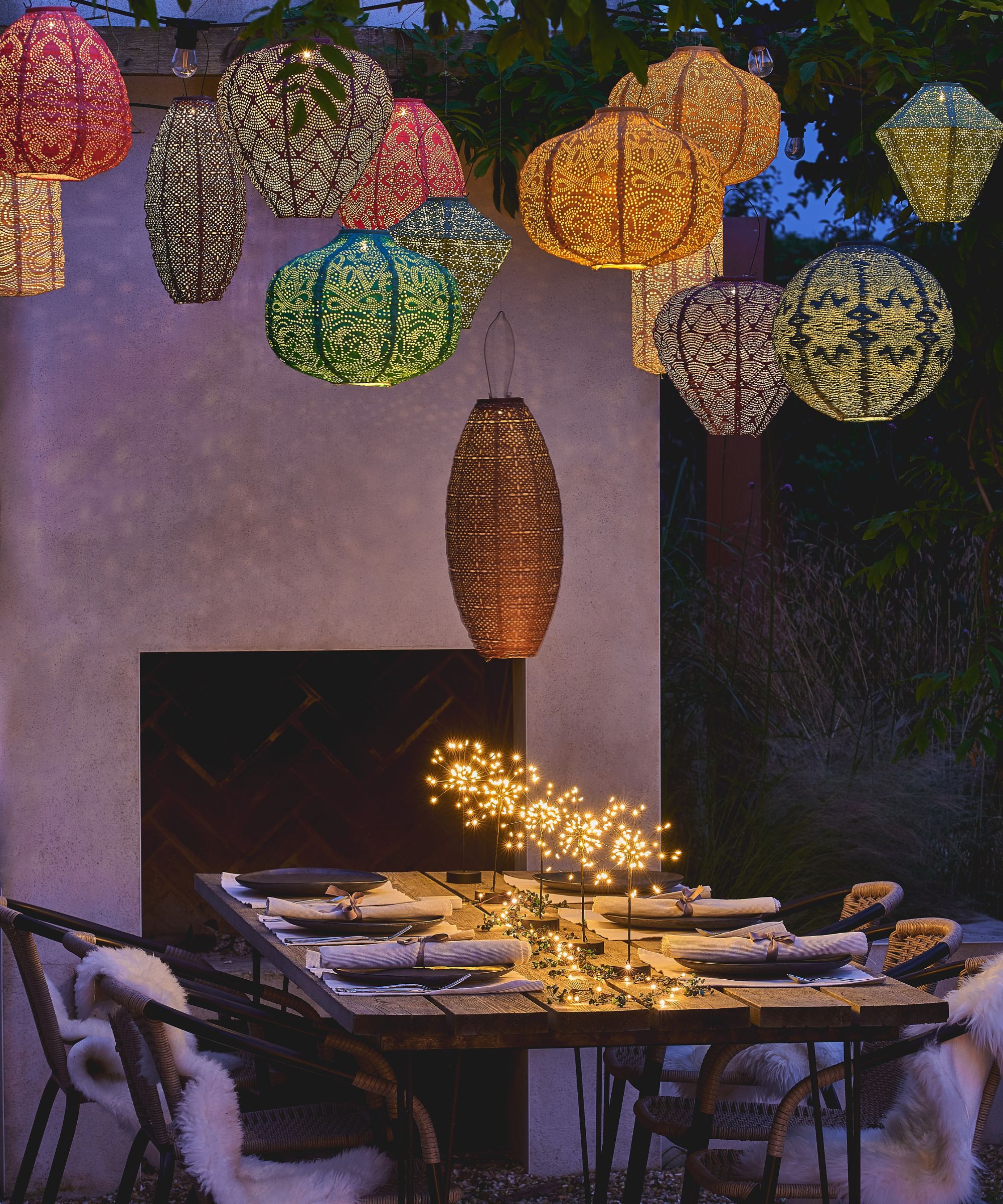 colourful floating lanterns above a table