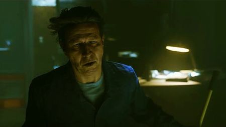 Ahti looks at the screen in Control