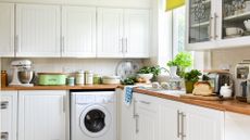  Cream kitchen with cluttered worktops with kitchen accessories and food