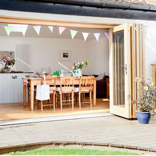 garden area with folding doors and bunting flag
