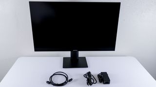 The Arzopa M3RC unboxed and set up on a desk alongside its power adapter and an HDMI cable