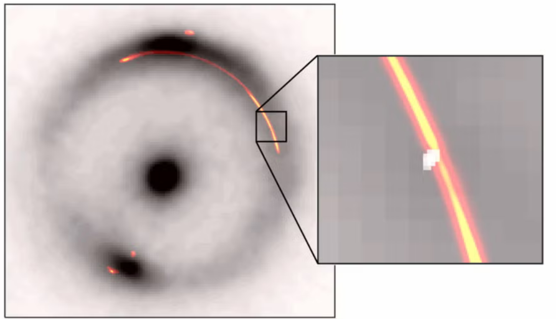 On the left, two black blobs in a box with a white and gray hazy background. A red-orange glowing ring is visible around the central blob. On the right, a close-up of the ring shows a white dot.