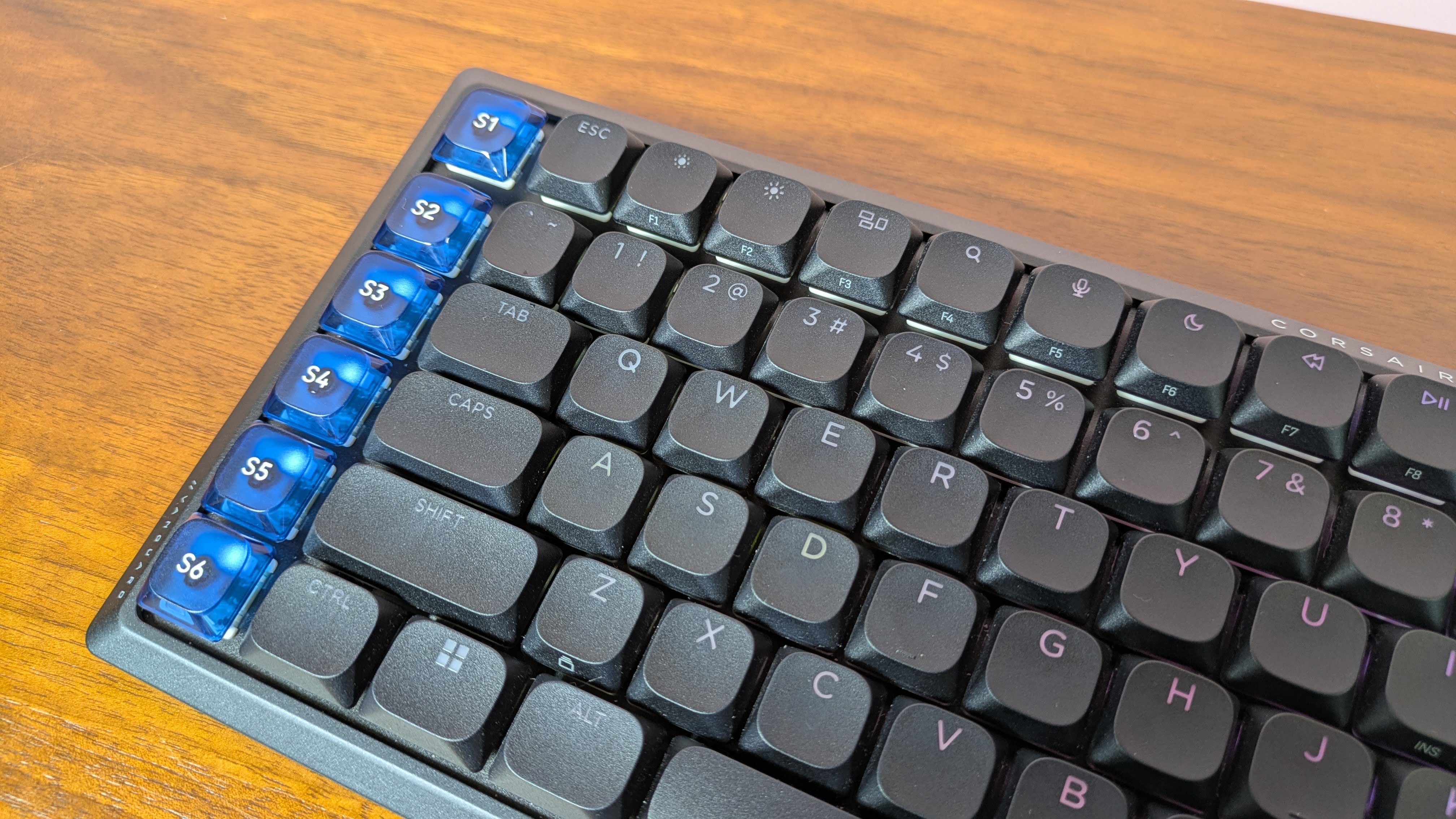 Close-up of keys on Corsair Vanguard Air 99 Wireless on brown desk