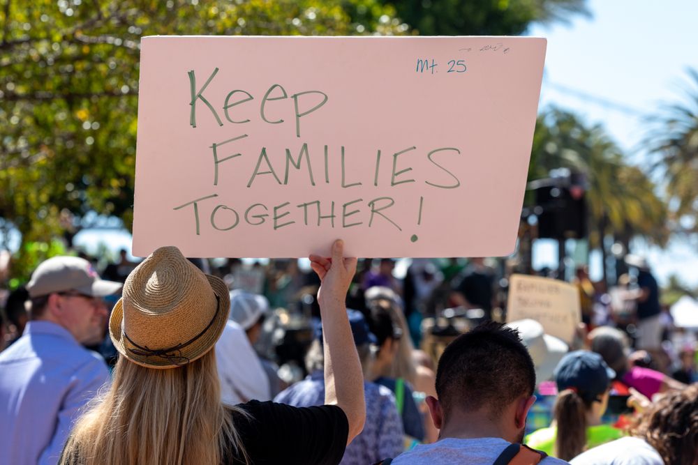 Person holding a &amp;quot;Keep Families Together&amp;quot; sign at a protest