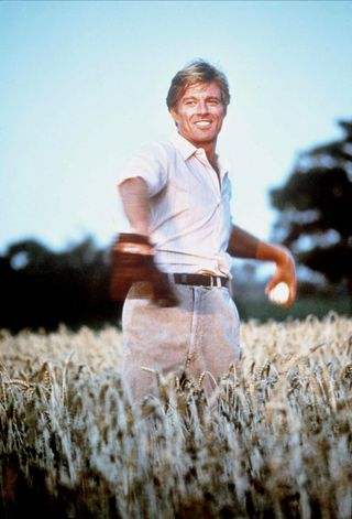 robert redford as a baseball player running through a field in The Natural