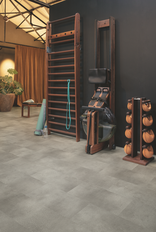 A home gym with concrete effect vinyl floors