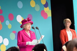 Queen Elizabeth II and Clare Balding are seen on stage during "The Patron's Lunch" celebrations for The Queen's 90th birthday at The Mall in 2016