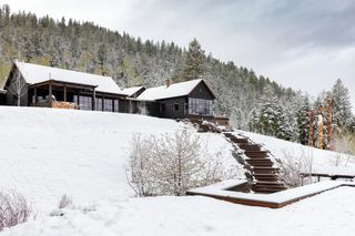 The main house at timber Wyoming retreat, seen in snow