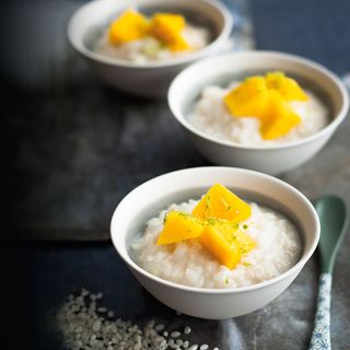 3 disches with rice and mango in them.