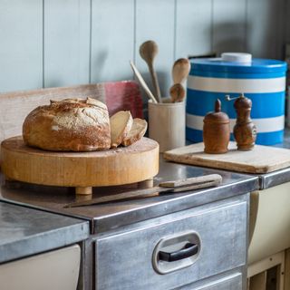 bread board with bread in a retro kitchen with metal unit