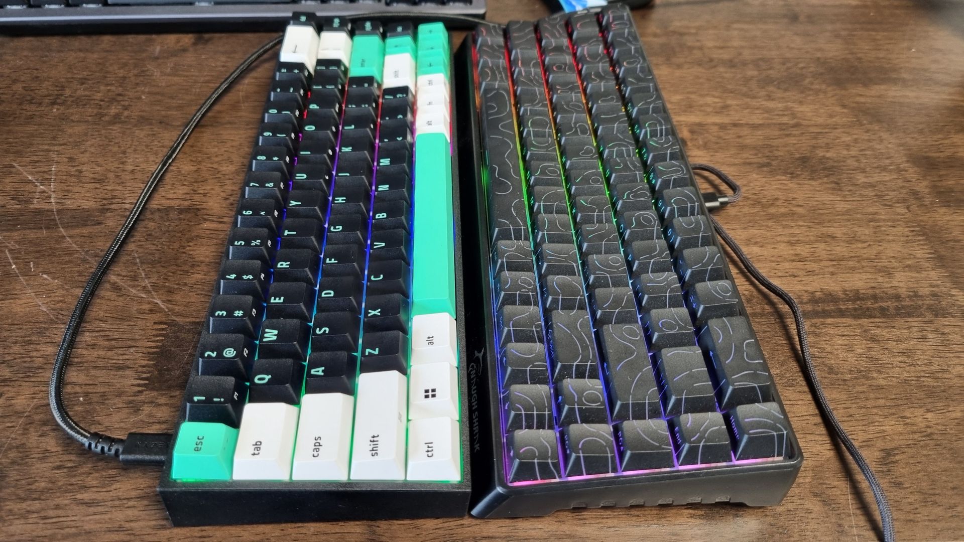 Two gaming keyboards pushed together on a desk