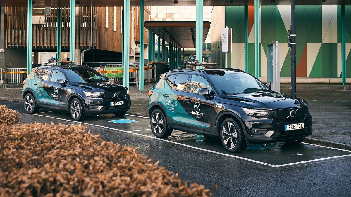 Volvo SUVs parked in wireless charging bays in a city center