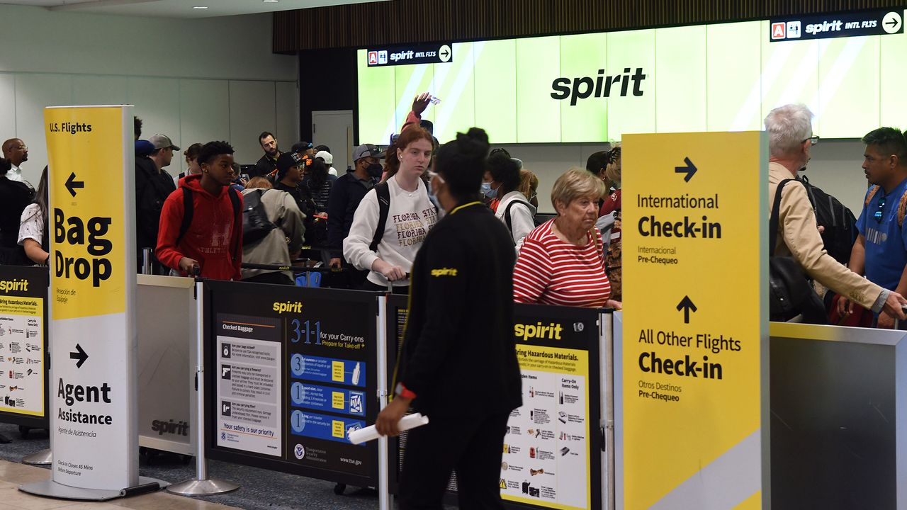 Travelers checking in at Spirit Airlines counter