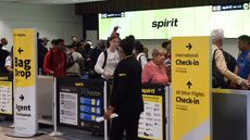 travelers checking in at Spirit Airlines counter