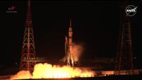 a rocket lifts off at night above a bright plume of fire