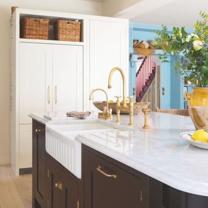 Country style kitchen with a large kitchen island and sink, with black cabinets