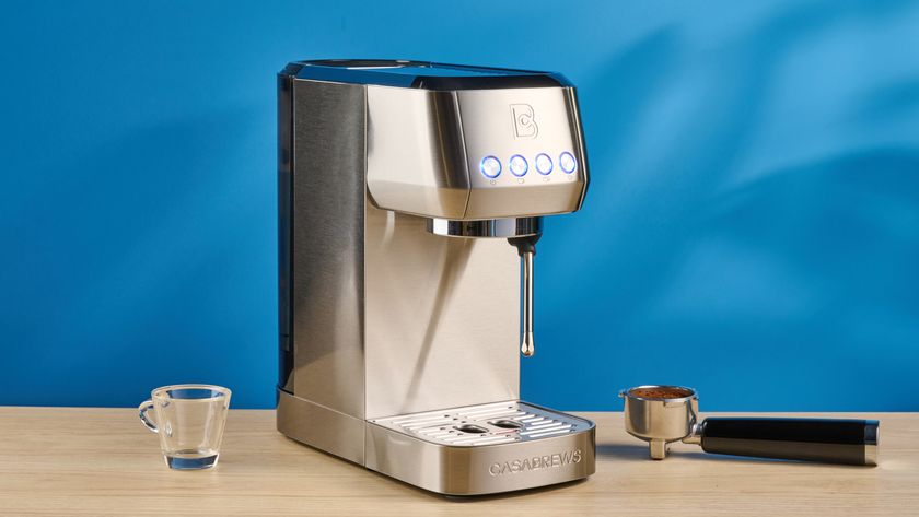 the casabrews 3700 essential espresso machine photographed against a blue background in stainless steel