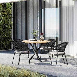 Round table on patio with black chairs