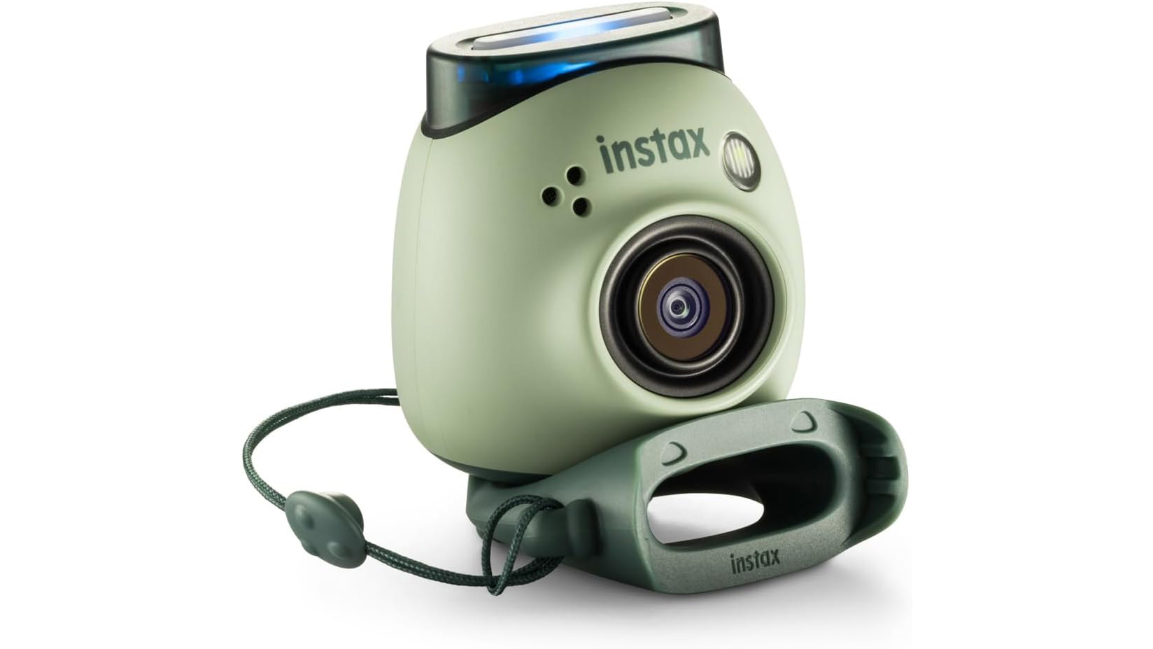 Fujifilm Instax Pal in green color on a white background. It's a three-quarters product shot with the Instax Pal aimed to the right and sat on top of its protective silicon case