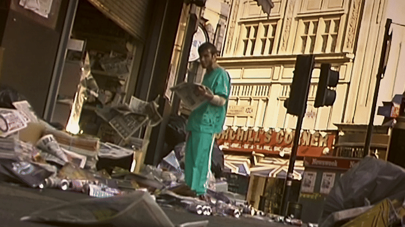 Clip from 28 Days Later showing protagonist in hospital scrubs reading newspaper in an abandoned London 