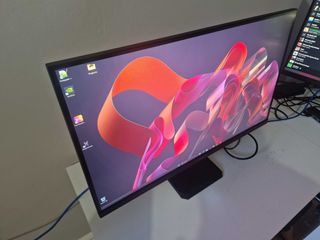 A Gigabyte M27U monitor on a white desk